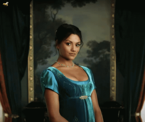Woman in Blue Dress Standing in Front of Picture