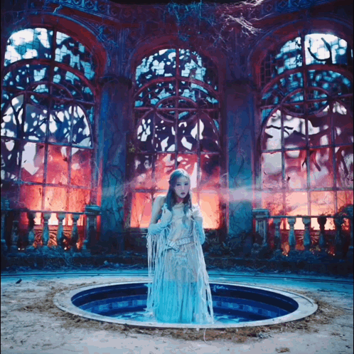 Woman In Blue Dress Standing In Pool GIF