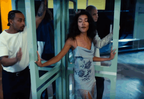 Woman In Blue Dress Surrounded By People GIF