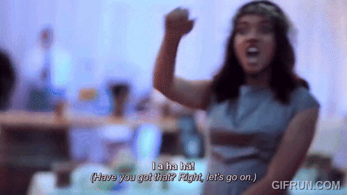 Woman in Blue Dress With Flower Crown Saying La Ha Ha