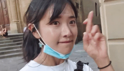 Woman in Blue Face Mask Making Peace Sign