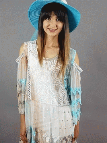 Woman in Blue Hat and White Top Smiling
