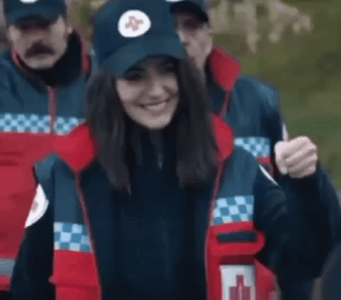 Woman in Blue Hat With Red Cross