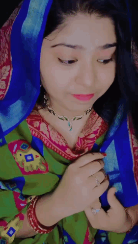 Woman in Blue Head Scarf and Green and Pink Dress