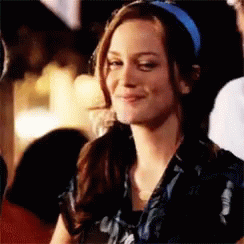 Woman In Blue Headband Smiling At Camera GIF