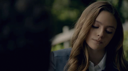 Woman In Blue Jacket And White Shirt Looking Down GIF
