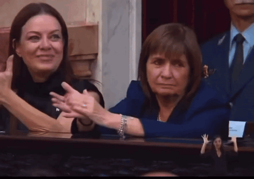 Woman in Blue Jacket Beside Woman in Black Dress