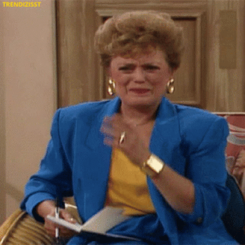 Woman in Blue Jacket Crying Holding Pen and Paper