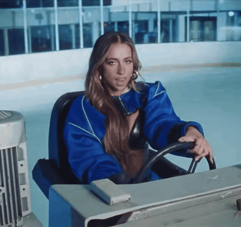 Woman in Blue Jacket Driving on Ice