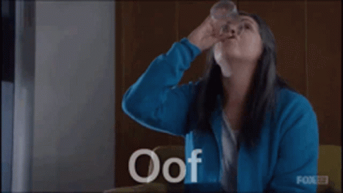 Woman in Blue Jacket Holding Water Glass