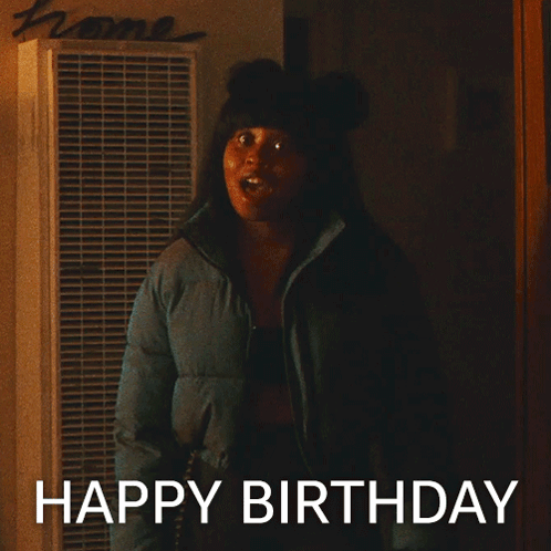 Woman In Blue Jacket In Front Of Home Sign GIF