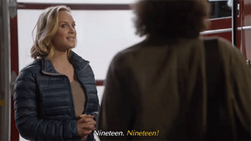 Woman in Blue Jacket Man Saying Nineteen Nineteen