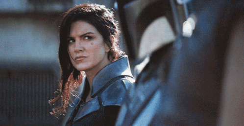 Woman in Blue Jacket Next to Man in Black Helmet