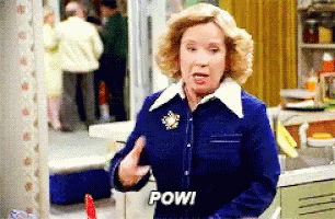 Woman In Blue Jacket Says Pow GIF
