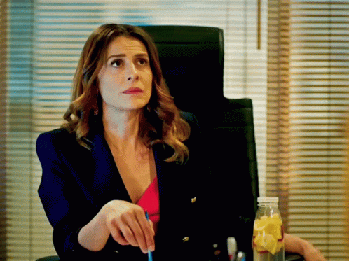 Woman In Blue Jacket Sitting In Office Chair GIF