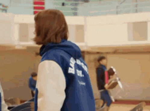 Woman in Blue Jacket With Hood in Gym