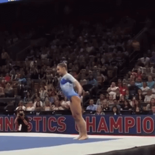 Woman in Blue Leotard Doing Gymnastics Trick