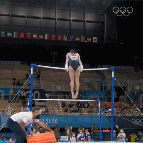 Woman in Blue Leotard Doing Parallel Bars