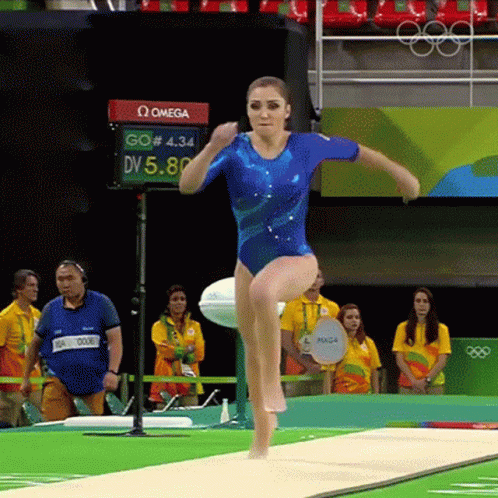 Woman in Blue Leotard Doing Trampoline Trick