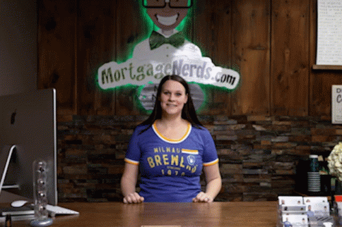 Woman in Blue Milwaukee Brewers Shirt at Desk
