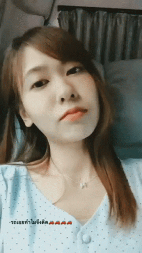 Woman in Blue Polka Dot Shirt With Foreign Language