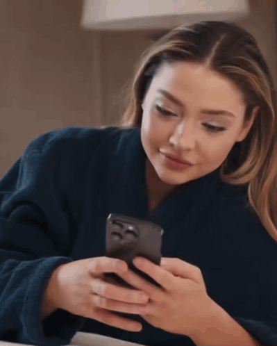 Woman in Blue Robe Checking Phone