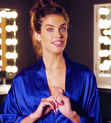 Woman in Blue Robe Smiling in Mirror
