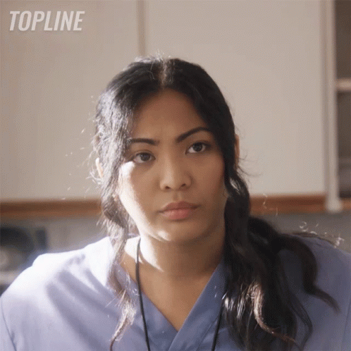 Woman in Blue Scrub Looking at Camera Topline