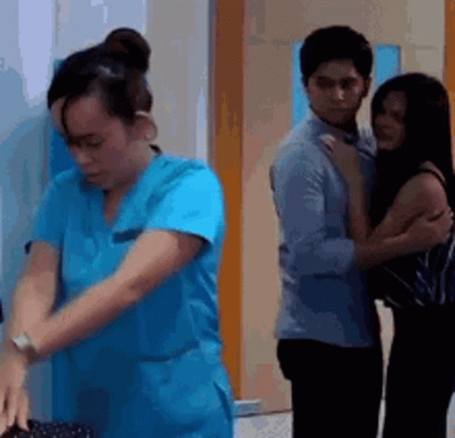 Woman in Blue Scrub Next to Man and Woman
