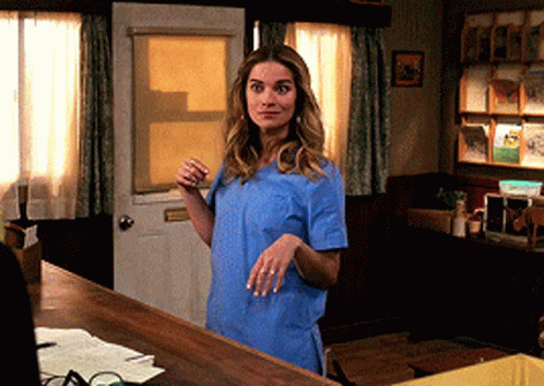 Woman In Blue Scrub Top At Door GIF