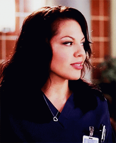 Woman In Blue Scrub Top With Name Tag On Pocket GIF