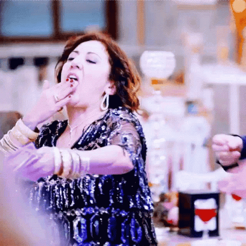 Woman In Blue Sequin Dress Covering Mouth GIF