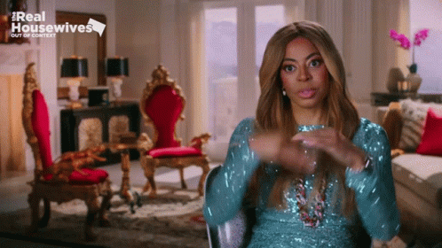Woman in Blue Sequined Dress Sitting in Living Room