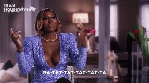 Woman In Blue Sequined Top In Front Of Real Housewives Sign GIF