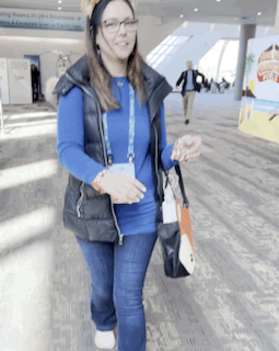 Woman in Blue Shirt and Black Vest Walking