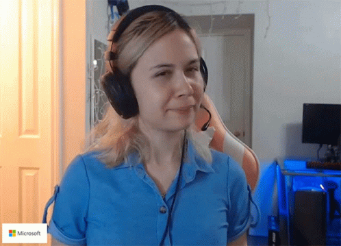 Woman in Blue Shirt and Headphones with Microsoft Logo