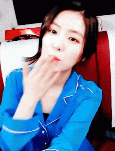 Woman in Blue Shirt Blowing Kiss