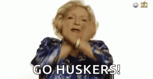 Woman in Blue Shirt Dancing Go Huskers!