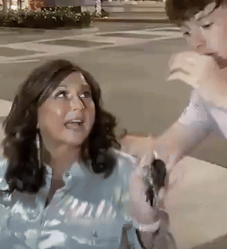 Woman in Blue Shirt Held by Man in White Shirt