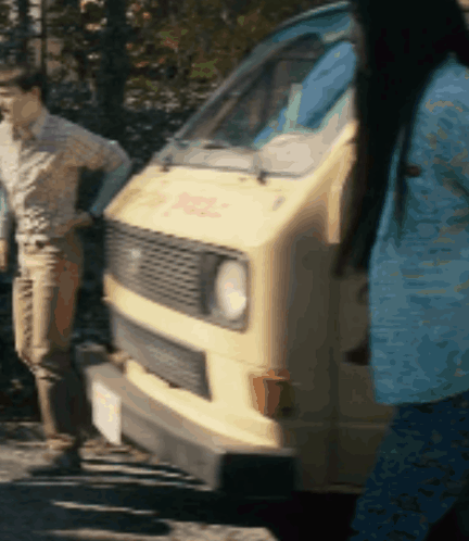 Woman in Blue Shirt in Front of DHL Van