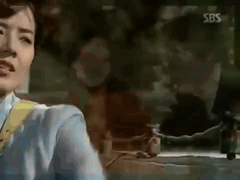 Woman In Blue Shirt In Front Of SBS Sign GIF