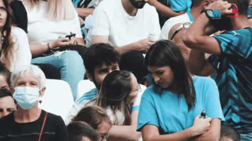 Woman in Blue Shirt Kissing Man
