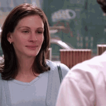 Woman In Blue Shirt Looking At Man In Pink GIF