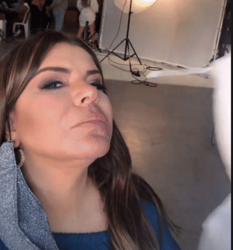 Woman in Blue Shirt Looking Down