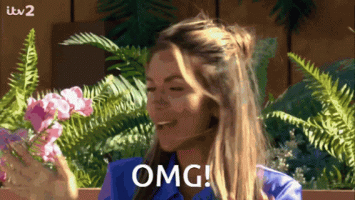 Woman in Blue Shirt Saying OMG With Flowers and Ferns