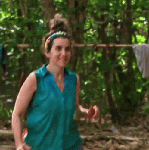 Woman in Blue Shirt Smiling in Woods