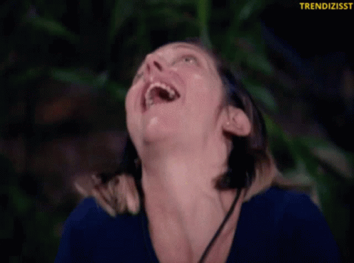 Woman in Blue Shirt Smiling Upward