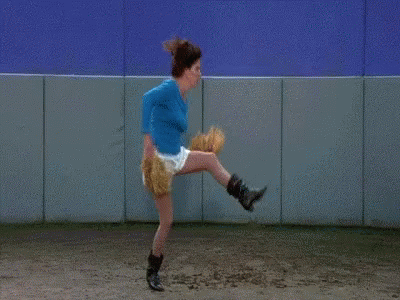 Woman in Blue Shirt Throwing Baseball
