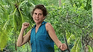 Woman in Blue Shirt with Arms Outstretched in Jungle
