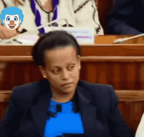 Woman In Blue Shirt With Clown Face On Head GIF